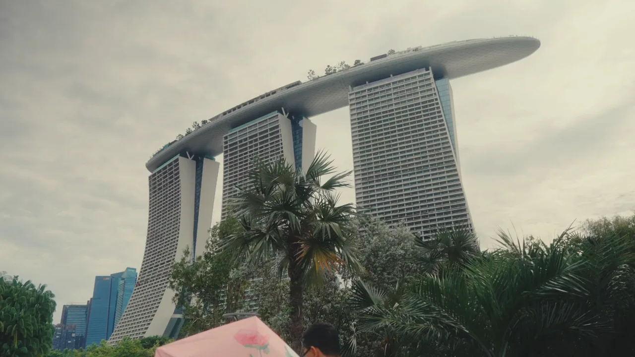 Marina Bay Sands rising above palm trees in Singapore.